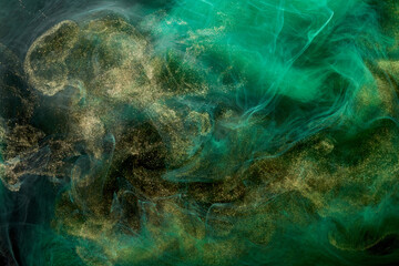 Fototapeta na wymiar Golden sparkling abstract background, luxury green smoke, acrylic paint underwater explosion, cosmic swirling ink