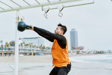 Young athlete training in the morning on the beach at the gym. outdoor. Representation of sport and...