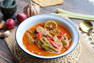 Thai Red curry with morning glory and pork belly - Authentic Thai food called Kang Tay po or Geang Tay po at close up view