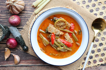 Red curry with morning glory and pork belly - Authentic Thai food called Kang Tay po or Geang Tay po at close up view