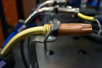 Welding torches for semi-automatic welder placed on a worktable