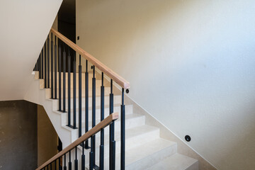 new stylish tile stairs with black metal railings in the house