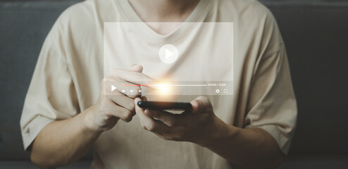 Video streaming online on smartphone with hologram. Man using smartphone on vacation. Social media and digital online concept.