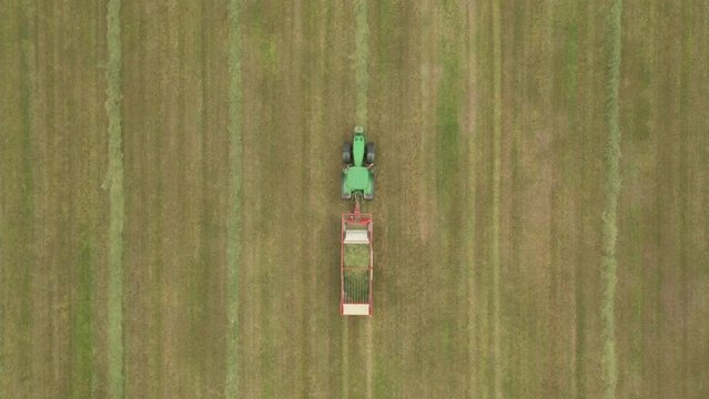 tractor working on the field, top view, tractor on green grass view from above