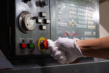 Press the emergency button on cnc machine control panel at factory,concept of prevention before damage of CNC machines