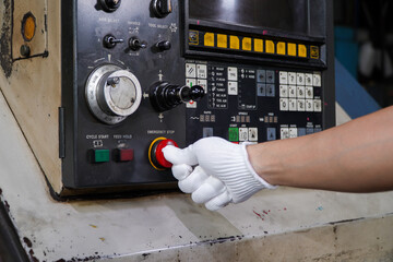 Press the emergency button on cnc machine control panel at factory,concept of prevention before damage of CNC machines