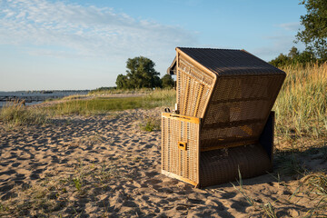 Beach chair at Harriersand Beach, Schwanewede Germany. Relaxing  under blue sky, warm sand, green...