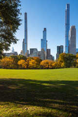 Midtown Manhattan view of Central Park in Fall with Billionaires' Row skyscrapers from Sheep Meadow. New York City
