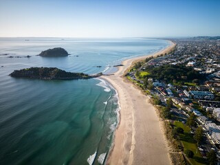 Fototapeta premium Aerial view of Mount Maunganui with Bay of Plenty and modern buildings, Tauranga, New Zealand