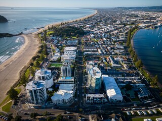 Fototapeta premium Aerial view of Mount Maunganui with Bay of Plenty and modern buildings, Tauranga, New Zealand