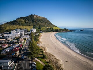 Fototapeta premium Aerial view of Mount Maunganui with Bay of Plenty and modern buildings, Tauranga, New Zealand