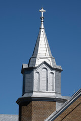 Fototapeta na wymiar A beautiful catholic church bell tower on a blue sky