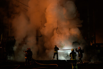 Firemen extinguished fire through the smoke