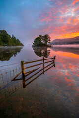 Beautiful sunrise reflections at Derwentwater in the Lake District, UK.