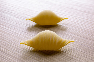 Fototapeta premium small compositions of durum wheat pasta on wooden background