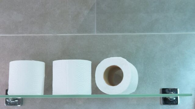 Stop motion animation toilet paper on the shelf in the bathroom. Paper rolls in the toilet.
