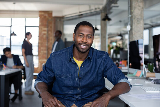 Portrait of African American businessman sitting at desk in an office