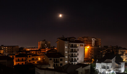 night landscape over city with moon aversa