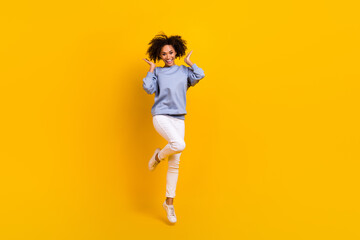 Fototapeta na wymiar Full size portrait of overjoyed pretty lady jumping hands touch wavy hairdo isolated on yellow color background
