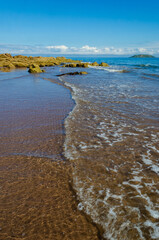 Sandy beach at Southend near Mull of Kintyre Scotland with sand ripples and waves with motion blur