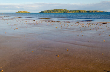 Evening light on Scottish beach at Southend near the Mull of Kintyre with Sanda Island and Sheep Island and copy space