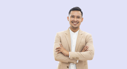 Portrait young Asian business man handsome arms crossed happy smile and looking at camera on brown isolated studio background.
