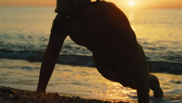 man does push-ups in the water with gas mask