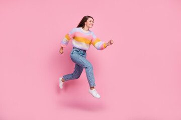Full length profile portrait of active excited girl jump rush look empty space isolated on pink color background