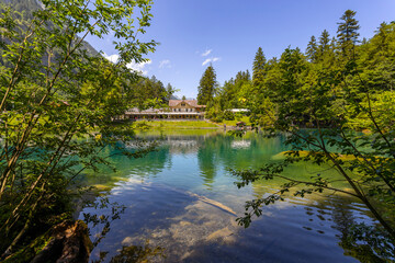 Obraz premium View of Blausee (The Blue lake) in Bernese Oberland, famous tourist destination in Switzerland