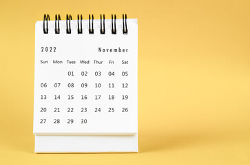 The November 2022 Monthly desk calendar for 2022 year on yellow background.