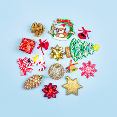 Christmas composition. Christmas gifts, decor, toys on a blue background in the form of a circle. Flat lay, top view.