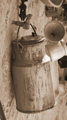 Fototapeta premium Rusty Pot Hanging on the Wall. Aged Household Things. Domestic Rustic Staff. Brown Retro Background.
