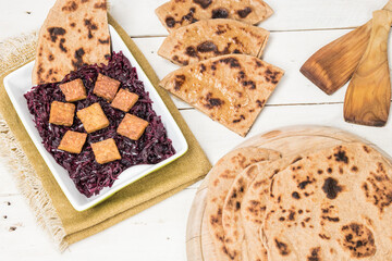 Vegan version of traditional Slovakia food. Savory whole grain flatbread. Salty pancakes. Served with red cabbage and tempeh. Full of carbohydrates.