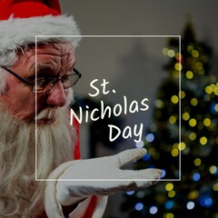 Composition of st nicholas day text over santa claus blowing dust off hand