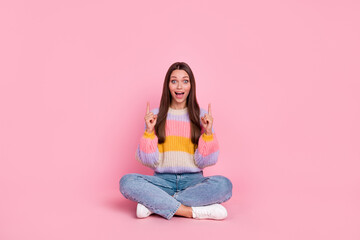 Obraz na płótnie Canvas Full size portrait of excited positive girl indicate fingers up empty space isolated on pink color background