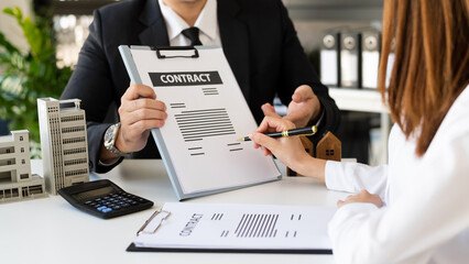 Sales giving male customer signing sales contract, Asian woman and man doing business in office, business concept and contract signing.