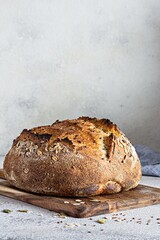 Fresh homemade bread (slice) from whole grain sourdough flour with the addition of bran, seeds (sunflower, pumpkin, flax, sesame) and oatmeal flakes. Healthy food. High quality photo.