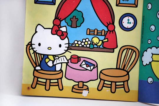 Hello Kitty Storybook. Kitty reading a letter at home.  Famous characters. Adorable kitten. Character from Japan. Produced by the Japanese company Sanrio. Isolated.