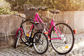 Fototapeta na wymiar Bicycles Lifestyle. Elegant Lilac Feminine Stylish Trendy Bikes with Basket. Girl's Bike Looks like Mom's Bicycle