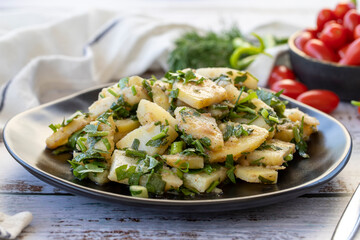 Potato salad. Fresh vegetarian salad on wood floor. close up