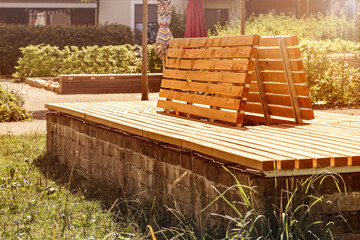 Bench in Modern Residential Yard. Modern Wooden Bench in Residential Complex. Public Yard Design.