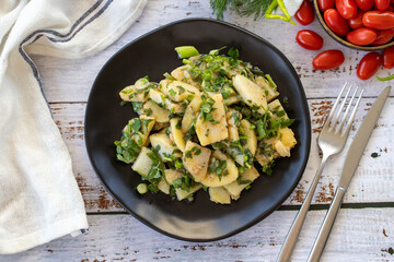Potato salad. Fresh vegetarian salad on wood floor. Top view