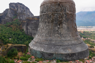 Close up view of bell on top of rock Aghio Pnevma (Holy Spirit). Panoramic view on valley between village of Kastraki and Pindus mountains. Rock complex of Meteora, Kalambaka, Thessaly, Greece, Europe