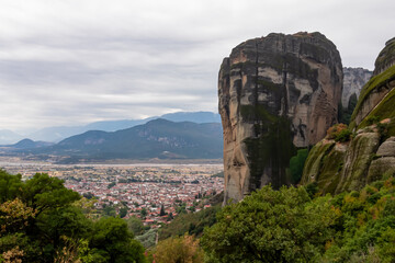 Panoramic aerial view of summit rock Aghio Pnevma (Holy Spirit) and tourist village of Kalambaka, Thessaly, Greece, Europe. Kastraki and the Pindus mountains. Dramatic rock complex of Meteora