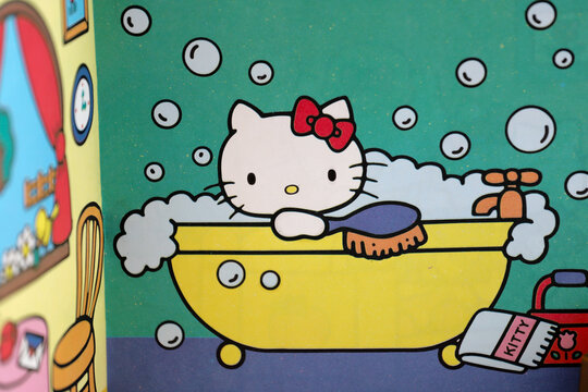 Hello Kitty taking a bubble bath in the bathtub. Storybook. Kitty reading a letter at home. Famous characters. Adorable kitten. Character from Japan. Produced by the Japanese company Sanrio. Isolated.