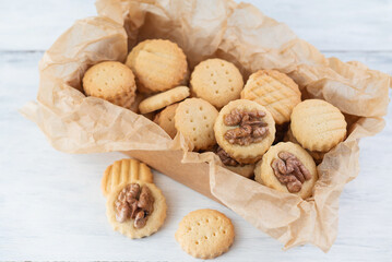 Blurred image of different cookies in a box on a light table.