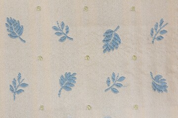 Closeup shot of a blue leaf patterned fabric textile surface