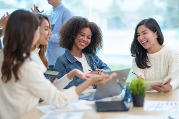 Group of young and energetic Asian business are meeting to start a new project in the company data is analyzed in different part of each department to analyze the strength and weaknesses.