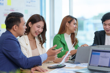 Group of young and energetic Asian business are meeting to start a new project in the company data is analyzed in different part of each department to analyze the strength and weaknesses.