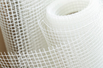 Polymer mesh for reinforcing walls and ceilings. Building material in a roll. Close-up. soft focus